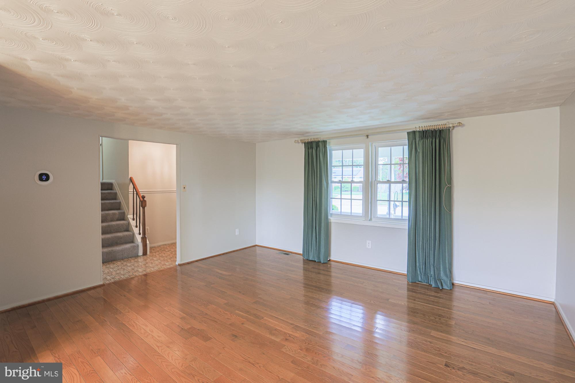 3923 Millner Road Baltimore, MD 21236 - Photo 6 of 38 an empty room with wooden floor and windows
