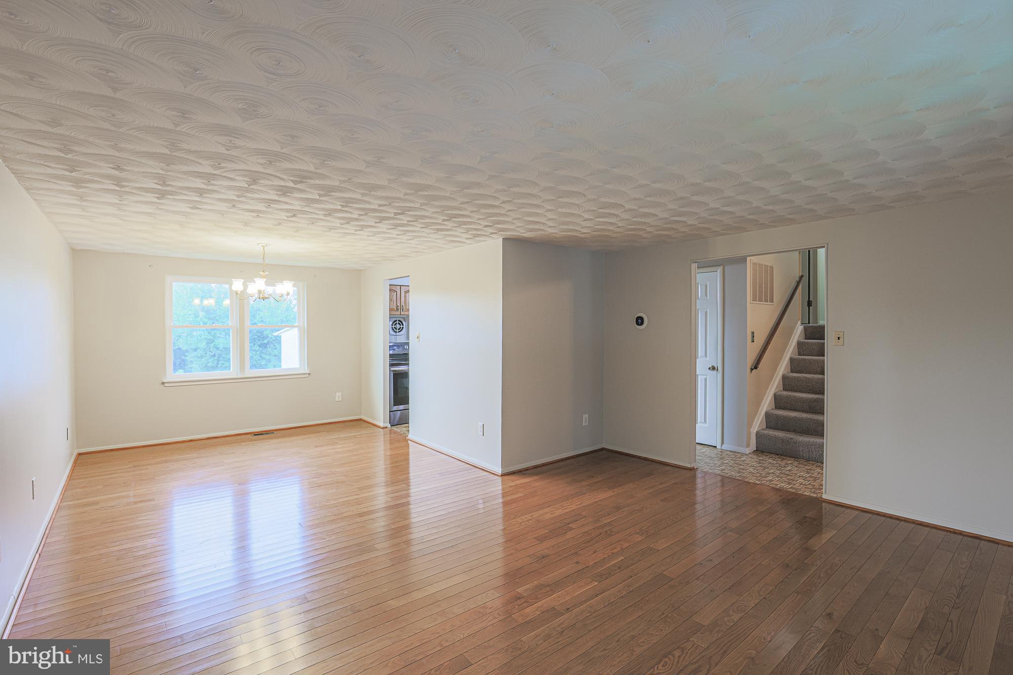 3923 Millner Road Baltimore, MD 21236 - Photo 8 of 38 a view of an empty room with wooden floor and a window