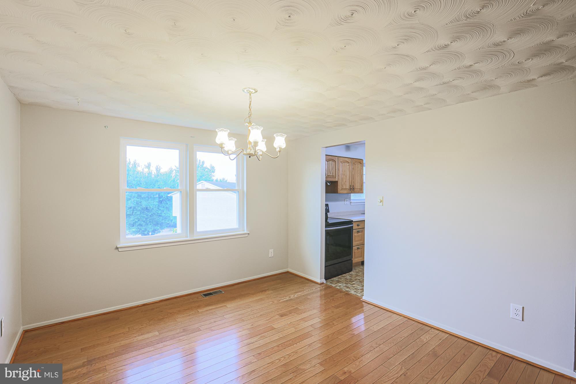 3923 Millner Road Baltimore, MD 21236 - Photo 9 of 38 wooden floor in an empty room with a window