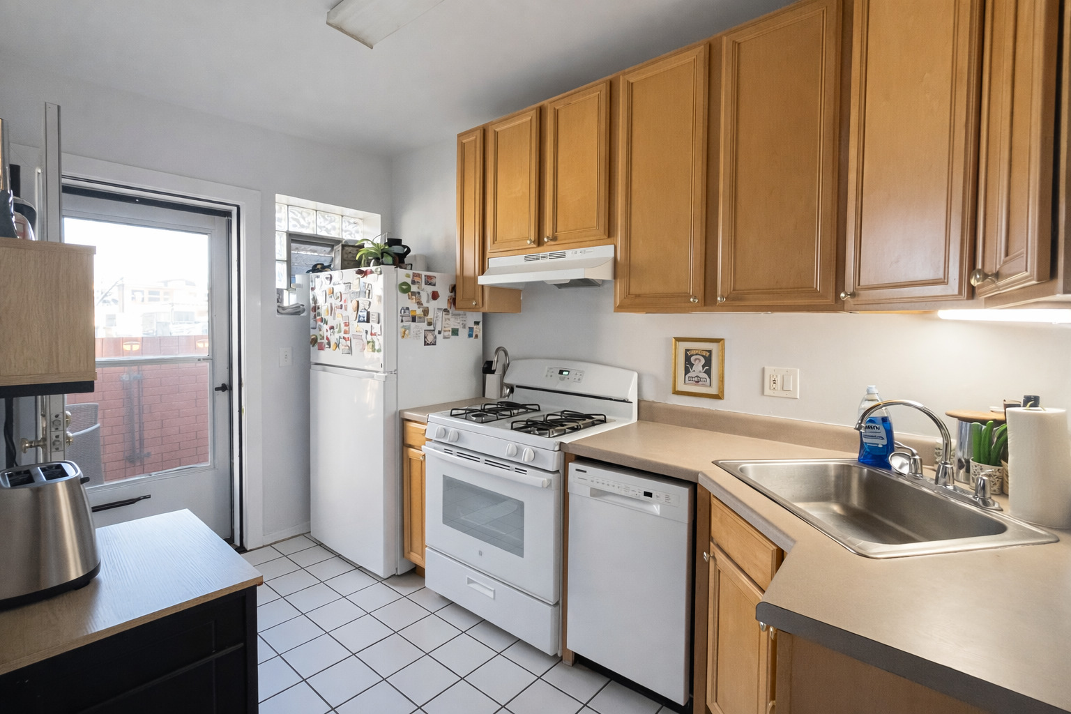 2461 North Clark Street, Unit 3 Chicago, IL 60614 - Photo 3 of 10 a kitchen with a sink stove and refrigerator