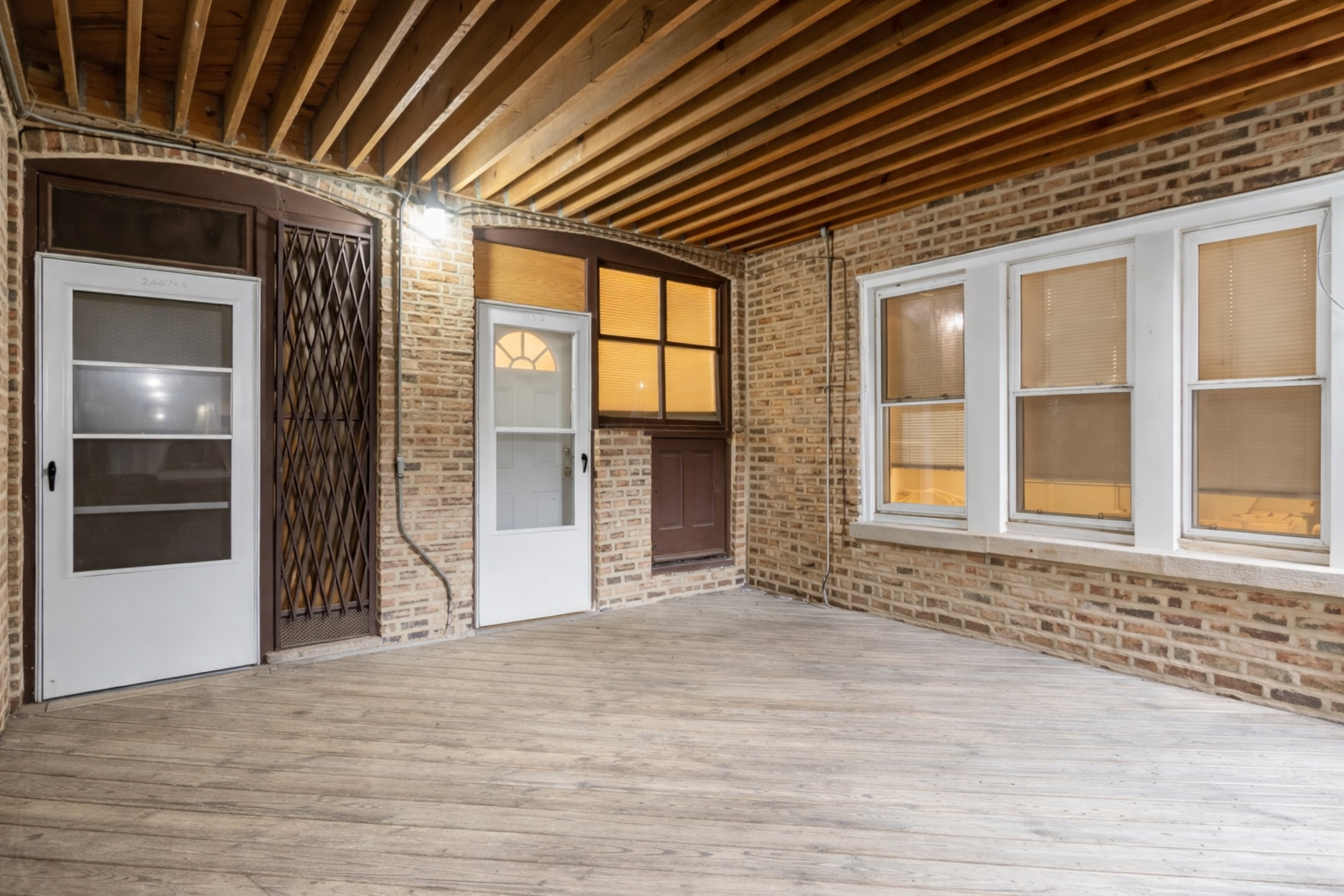 2461 North Clark Street, Unit 3 Chicago, IL 60614 - Photo 4 of 10 an empty room with wooden floor and windows