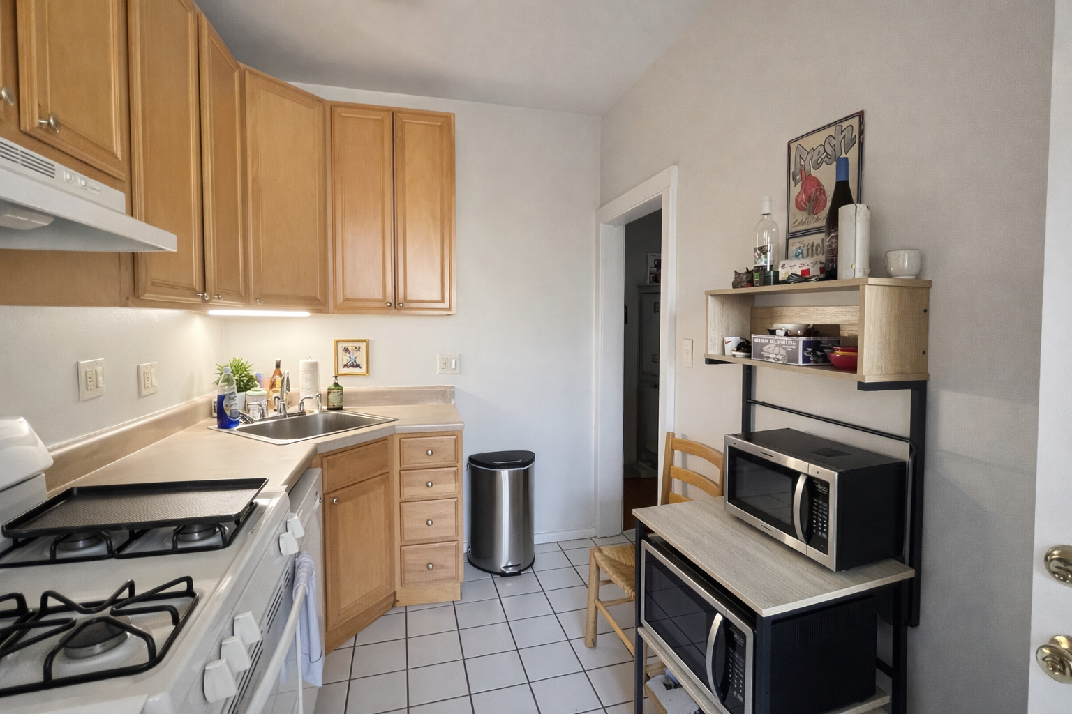 2461 North Clark Street, Unit 3 Chicago, IL 60614 - Photo 6 of 10 a kitchen with stainless steel appliances a stove a sink and a refrigerator
