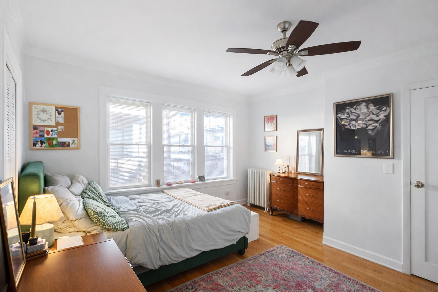 2461 North Clark Street, Unit 3 Chicago, IL 60614 - Photo 10 of 10 a bedroom with a bed and wooden floor