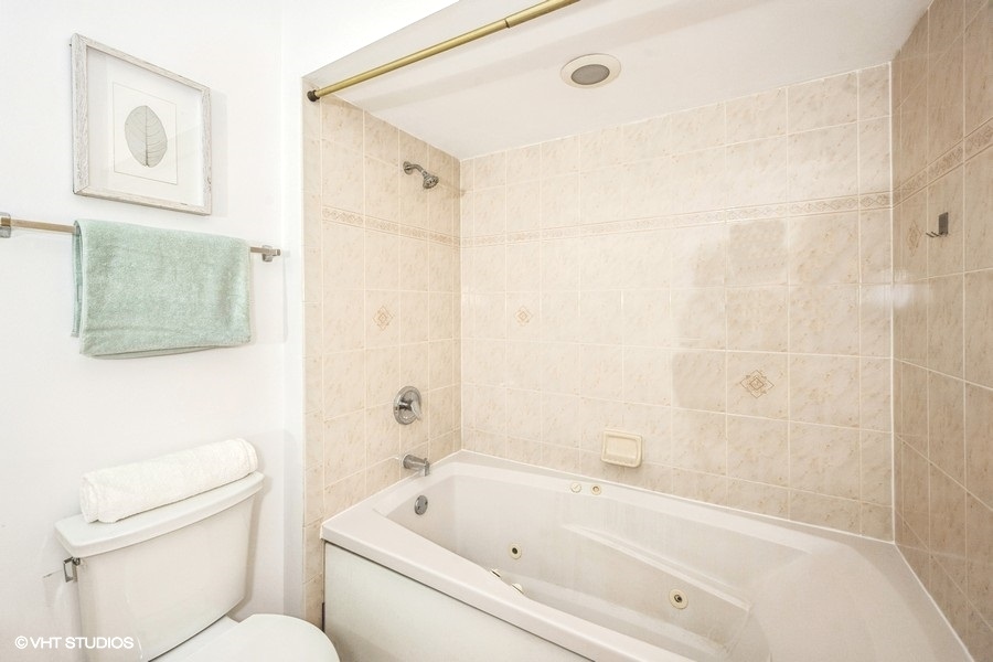 2002 West Potomac Avenue Chicago, IL 60622 - Photo 11 of 17 a bathroom with a bathtub shower sink vanity and toilet
