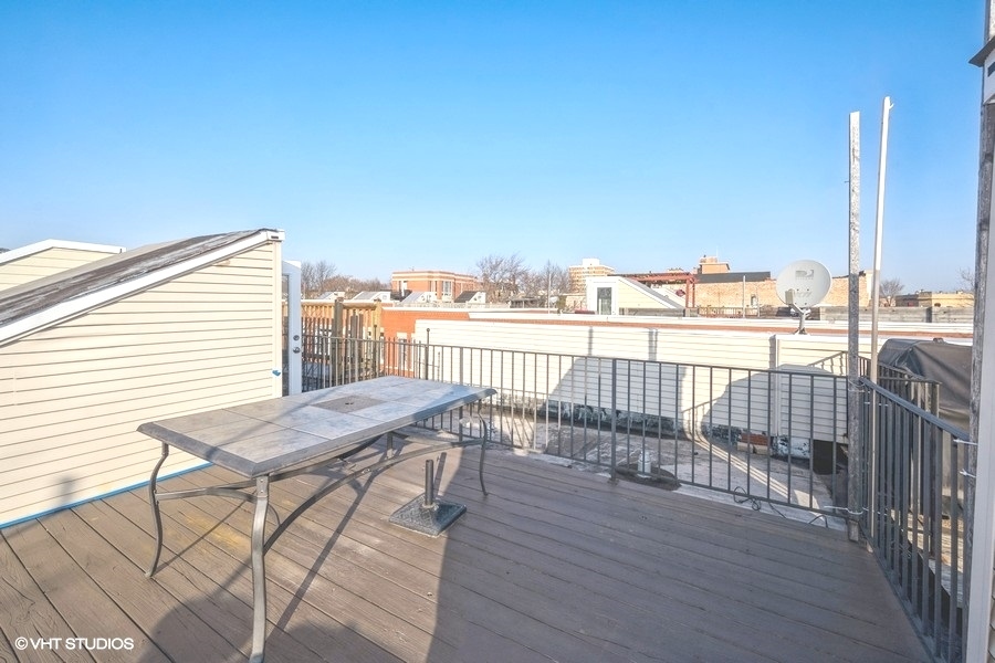 2002 West Potomac Avenue Chicago, IL 60622 - Photo 16 of 17 a view of a balcony with furniture and wooden floor