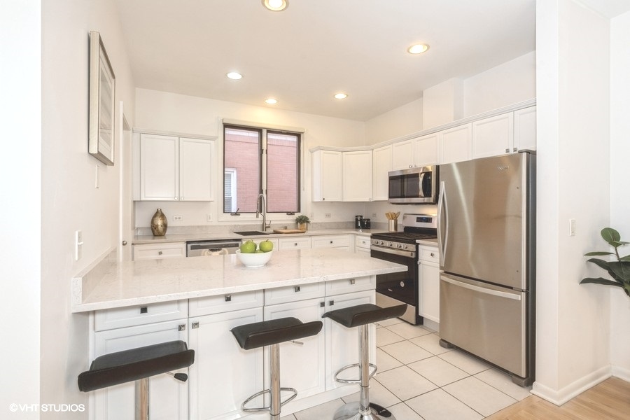 2002 West Potomac Avenue Chicago, IL 60622 - Photo 6 of 17 a kitchen with stainless steel appliances a refrigerator sink and cabinets