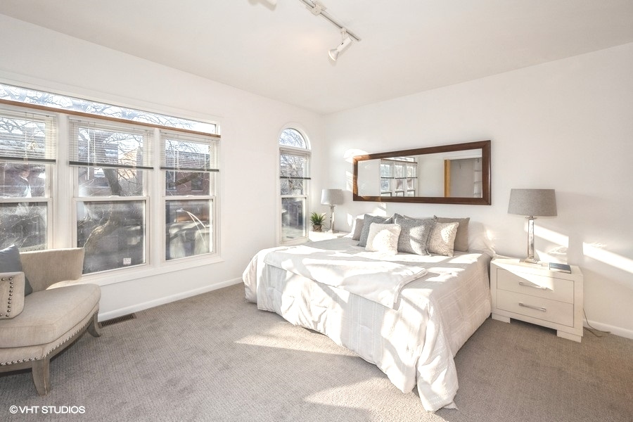 2002 West Potomac Avenue Chicago, IL 60622 - Photo 9 of 17 a spacious bedroom with a bed and a large window