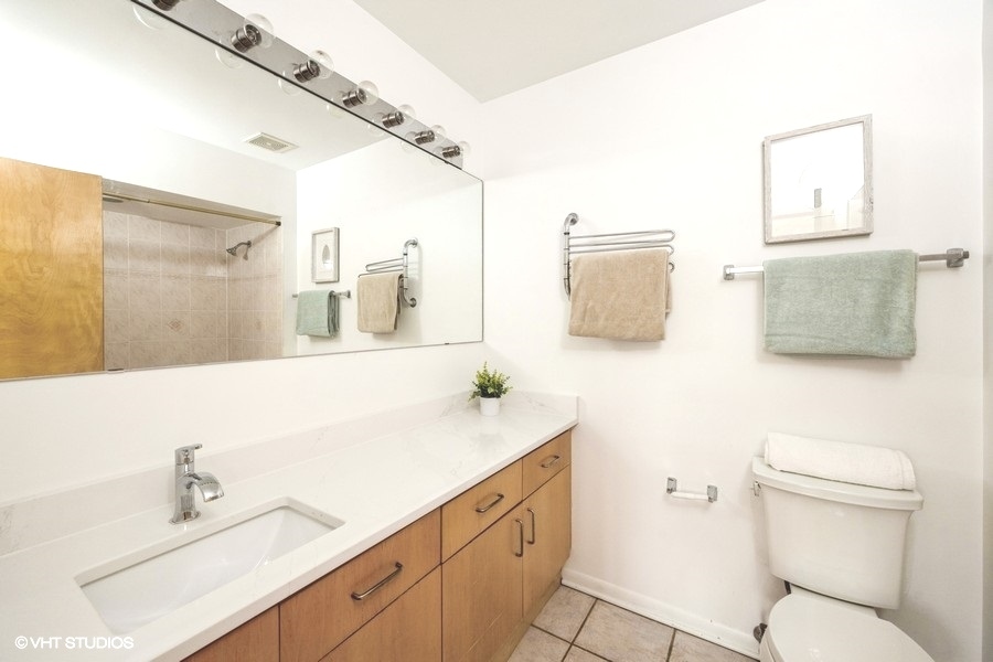 2002 West Potomac Avenue Chicago, IL 60622 - Photo 10 of 17 a bathroom with a sink toilet and mirror