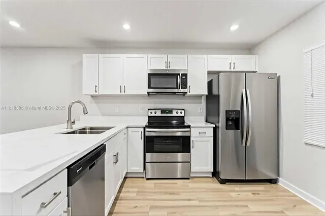 a kitchen with a sink stove and refrigerator