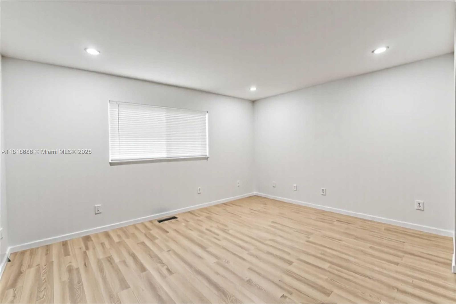 5790 Stirling Road, Unit 212 Hollywood, FL 33021 - Photo 17 of 22 an empty room with wooden floor and windows