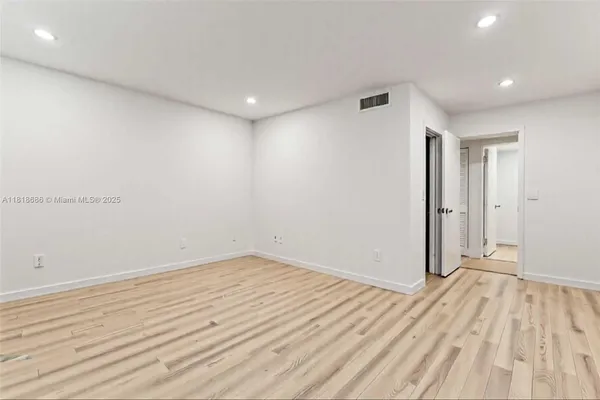 a view of room with wooden floor