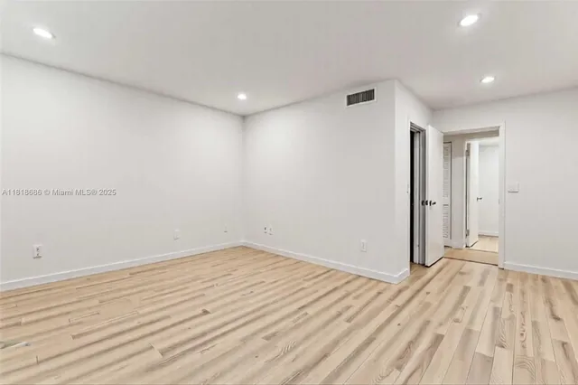 a view of room with wooden floor