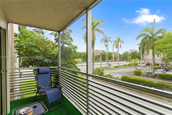 a view of a porch with furniture and next to a yard