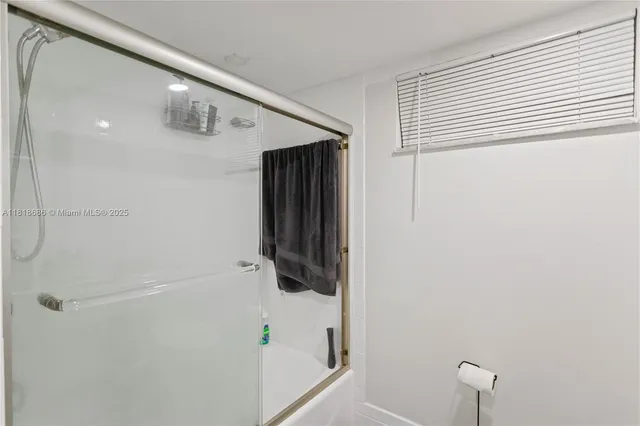a bathroom with a shower and a shower