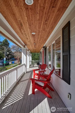 a view of a patio with table and chairs and wooden floor