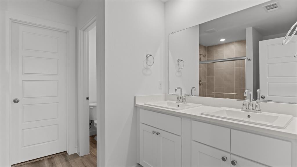 3408 Rendezvous Way Sherman, TX 75090 - Photo 13 of 21 Full bathroom with double vanity, light wood-style flooring, and a stall shower