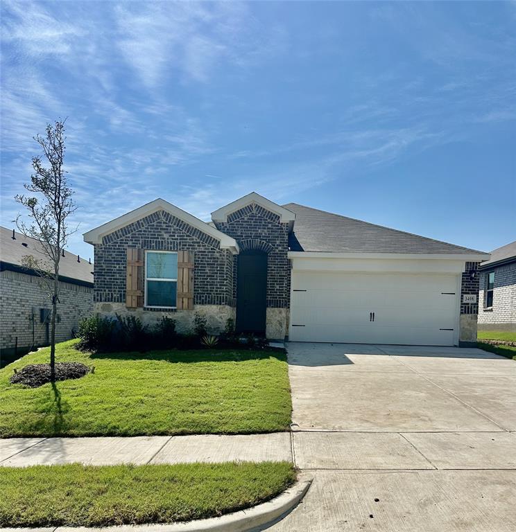 3408 Rendezvous Way Sherman, TX 75090 - Photo 20 of 21 View of front of home with a front lawn, concrete driveway, brick siding, and an attached garage
