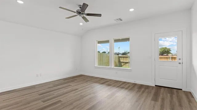 wooden floor in an empty room with a window