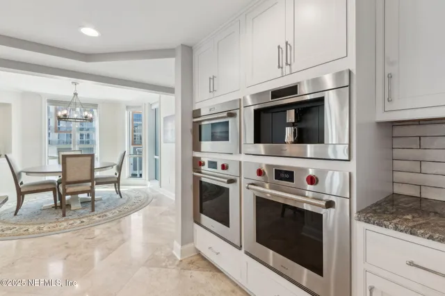 a dining room with furniture window and wooden floor
