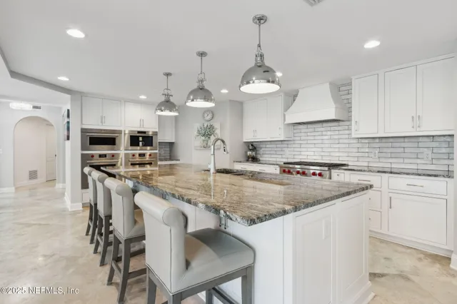 a kitchen with a stove a refrigerator and cabinets