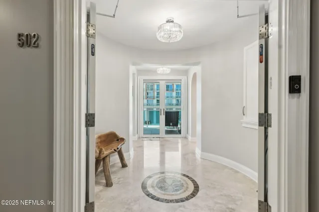 a kitchen with stainless steel appliances granite countertop a sink a stove a refrigerator cabinets and chairs