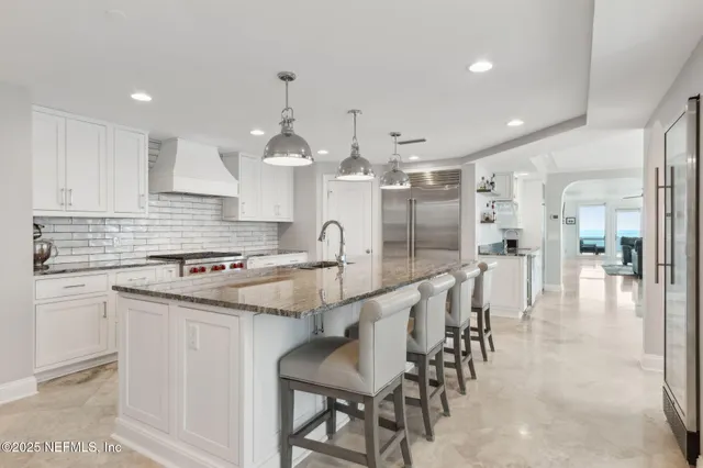 a kitchen with granite countertop a sink and a stove