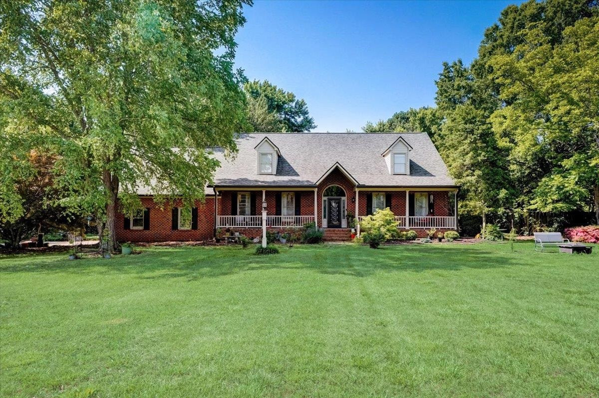 1446 Frazier Road Spring Hope, NC 27882 - Photo 1 of 28 a front view of a house with a garden