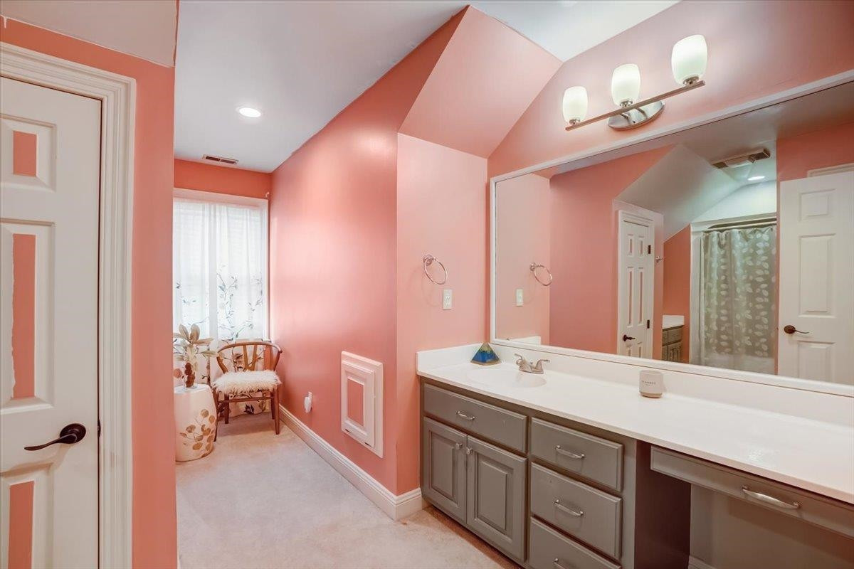 1446 Frazier Road Spring Hope, NC 27882 - Photo 17 of 28 a spacious bathroom with a double vanity sink a large mirror and a bathtub