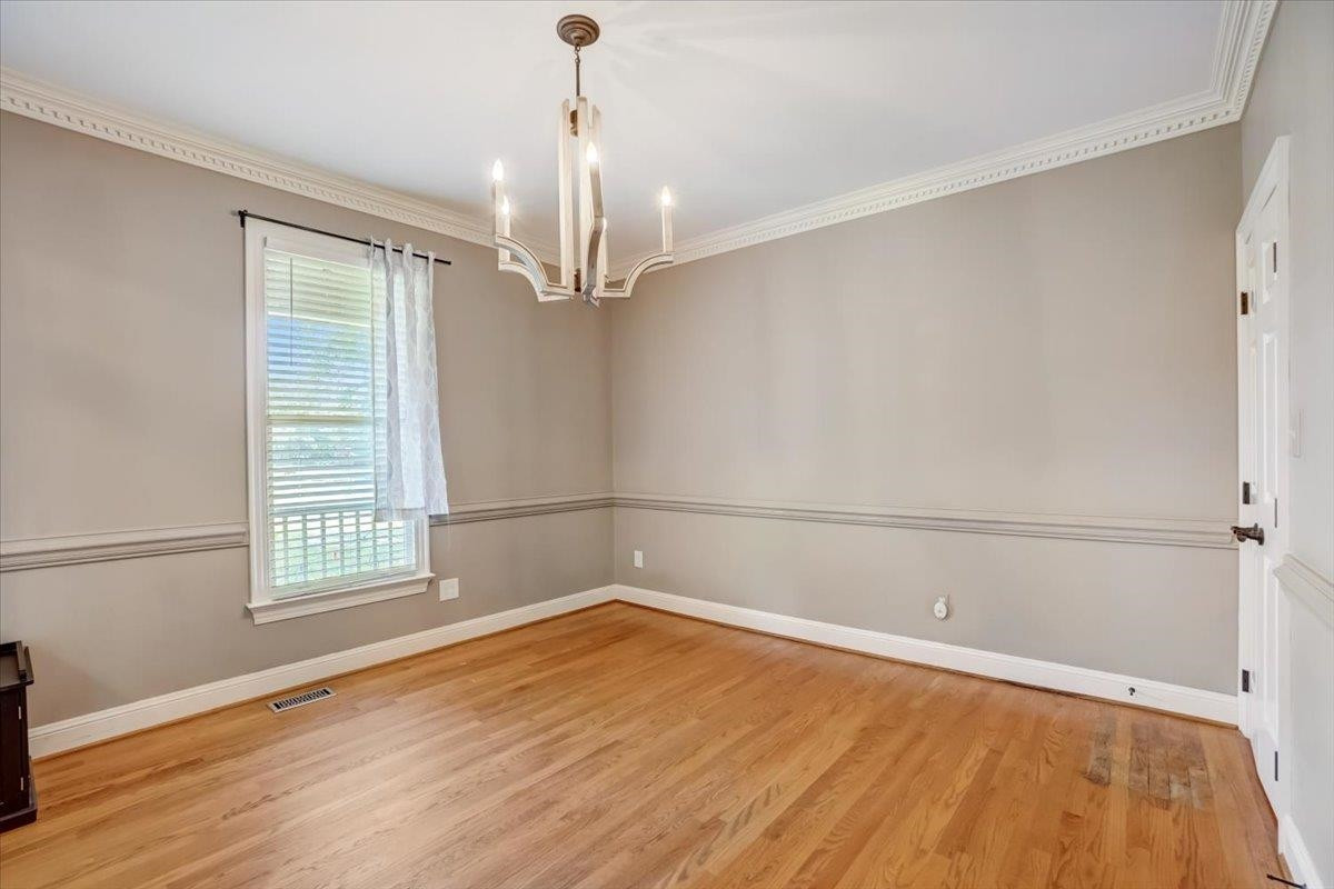 1446 Frazier Road Spring Hope, NC 27882 - Photo 5 of 28 a view of a room with wooden floor and white walls