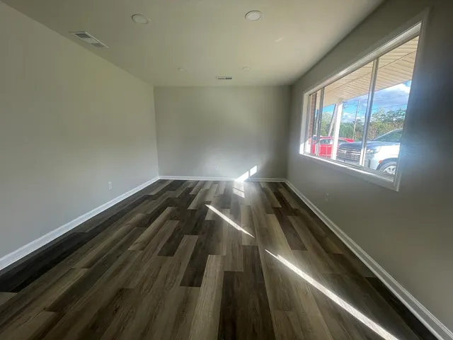 a kitchen with granite countertop a sink cabinets and stainless steel appliances