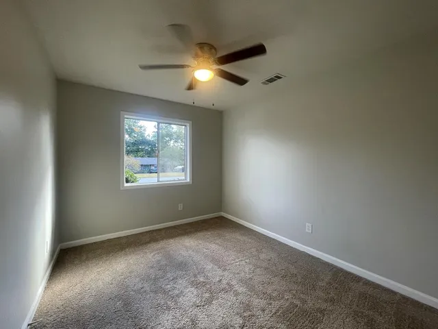 a view of storage and utility room with a fireplace and wooden floor