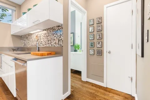 a bathroom with a granite countertop sink a toilet and shower