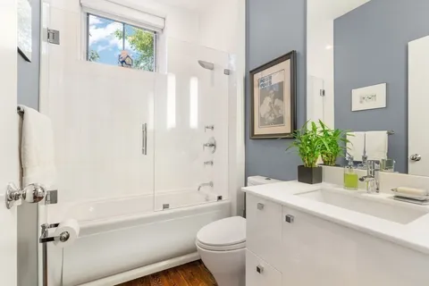 a front view of a house with a sink and wooden floor