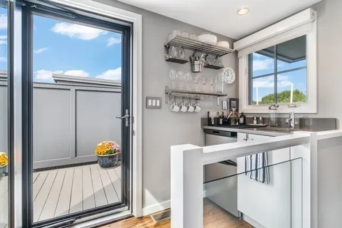 a view of a porch with furniture and a yard