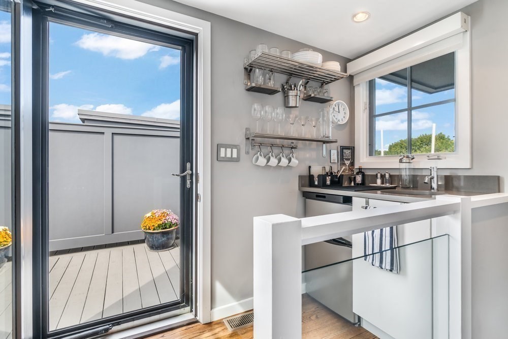 66 Seaverns Avenue, Unit 68B Boston, MA 02130 - Photo 19 of 30 a kitchen with a sink a window and cabinets