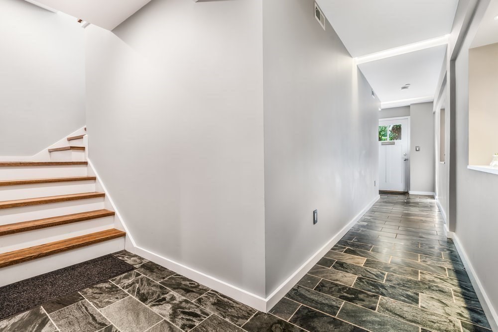 66 Seaverns Avenue, Unit 68B Boston, MA 02130 - Photo 21 of 30 a view of a hallway with wooden floor and white walls