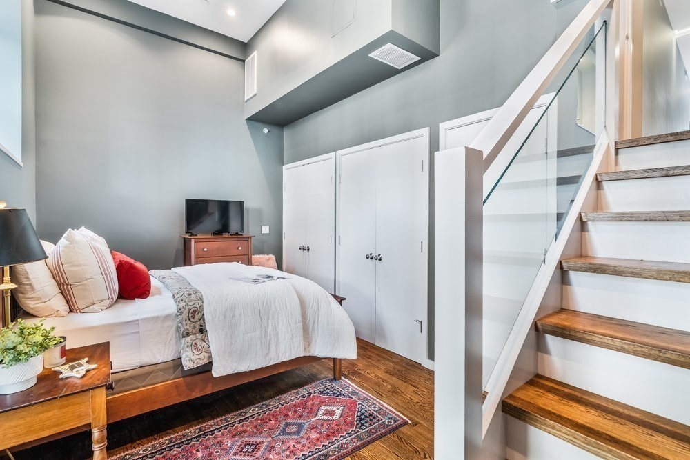 66 Seaverns Avenue, Unit 68B Boston, MA 02130 - Photo 22 of 30 a bedroom with a bed and wooden floor