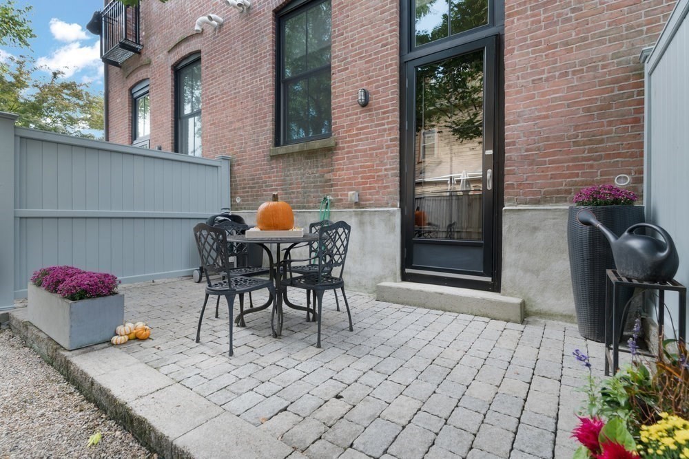 66 Seaverns Avenue, Unit 68B Boston, MA 02130 - Photo 24 of 30 a view of a dinning tables and chairs in a patio in front of a house