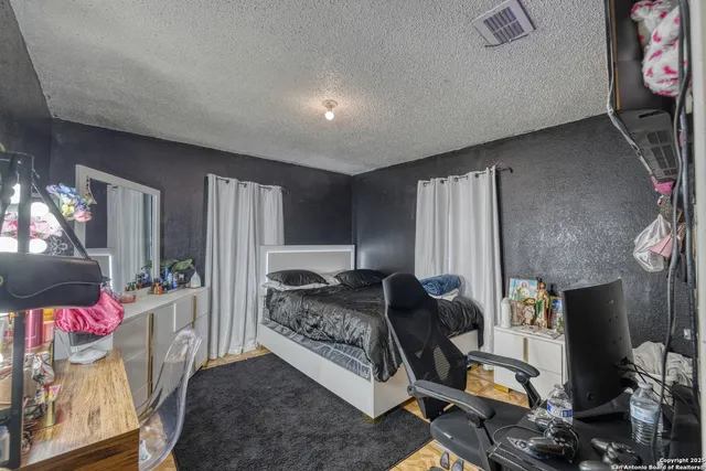 a living room with furniture a flat screen tv and a floor to ceiling window