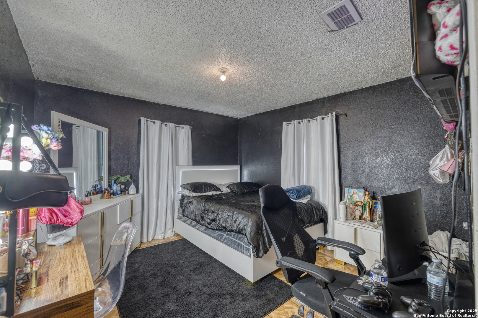 258 Prairie Street Uvalde, TX 78801 - Photo 11 of 19 a living room with furniture a flat screen tv and a floor to ceiling window