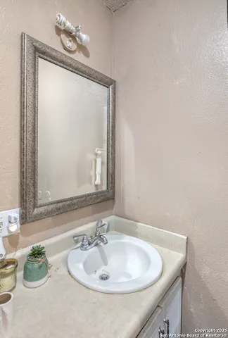 a bathroom with a sink and a mirror