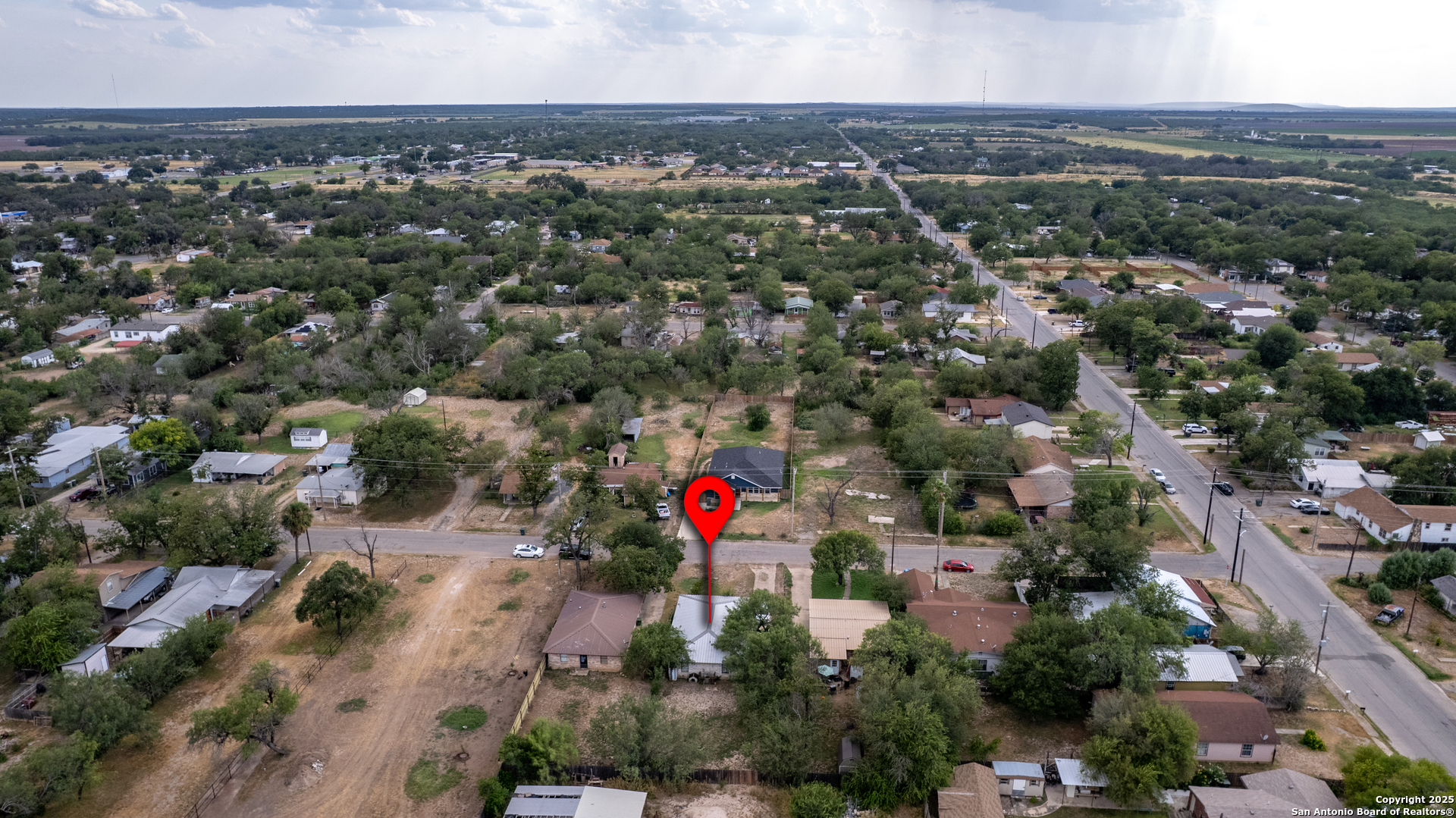 258 Prairie Street Uvalde, TX 78801 - Photo 18 of 19 an aerial view of green landscape with trees houses and mountain view