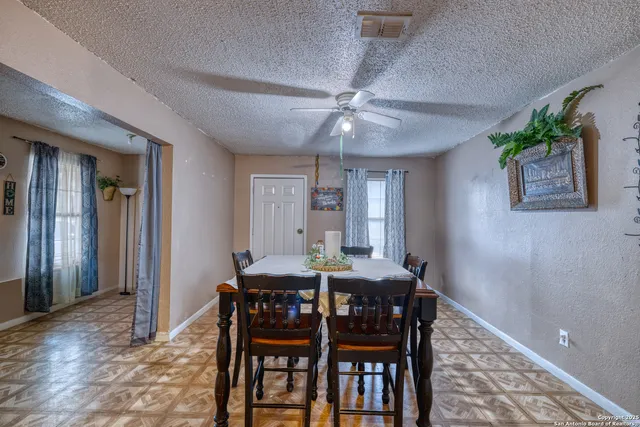 a dining room with furniture and window