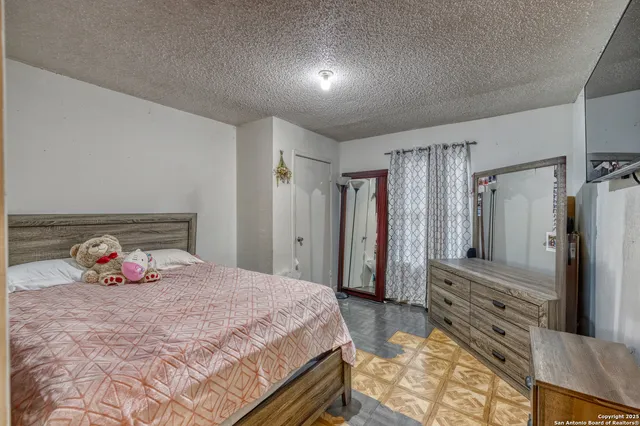 a bedroom with a bed and a large mirror