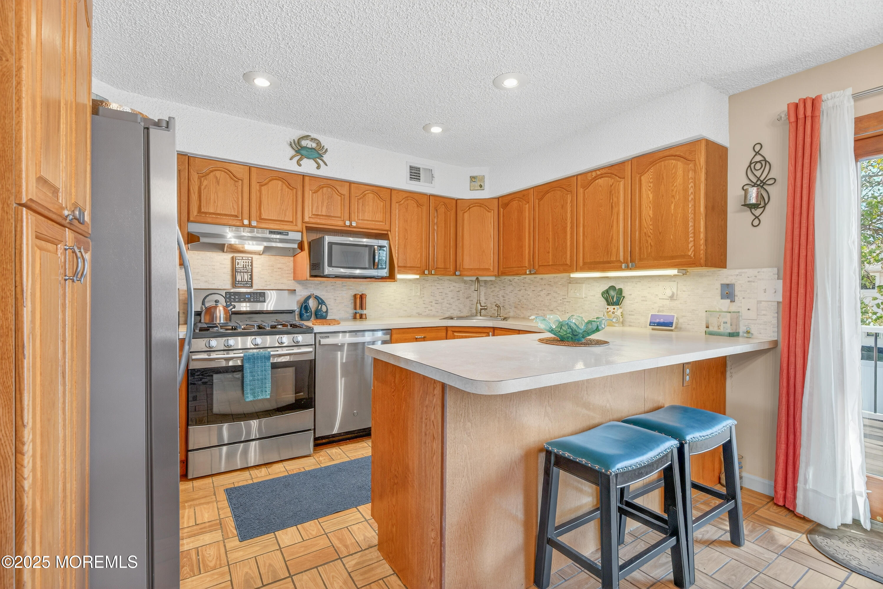 35 Heather Road Toms River, NJ 08753 - Photo 13 of 40 a kitchen with stainless steel appliances granite countertop a sink stove and refrigerator