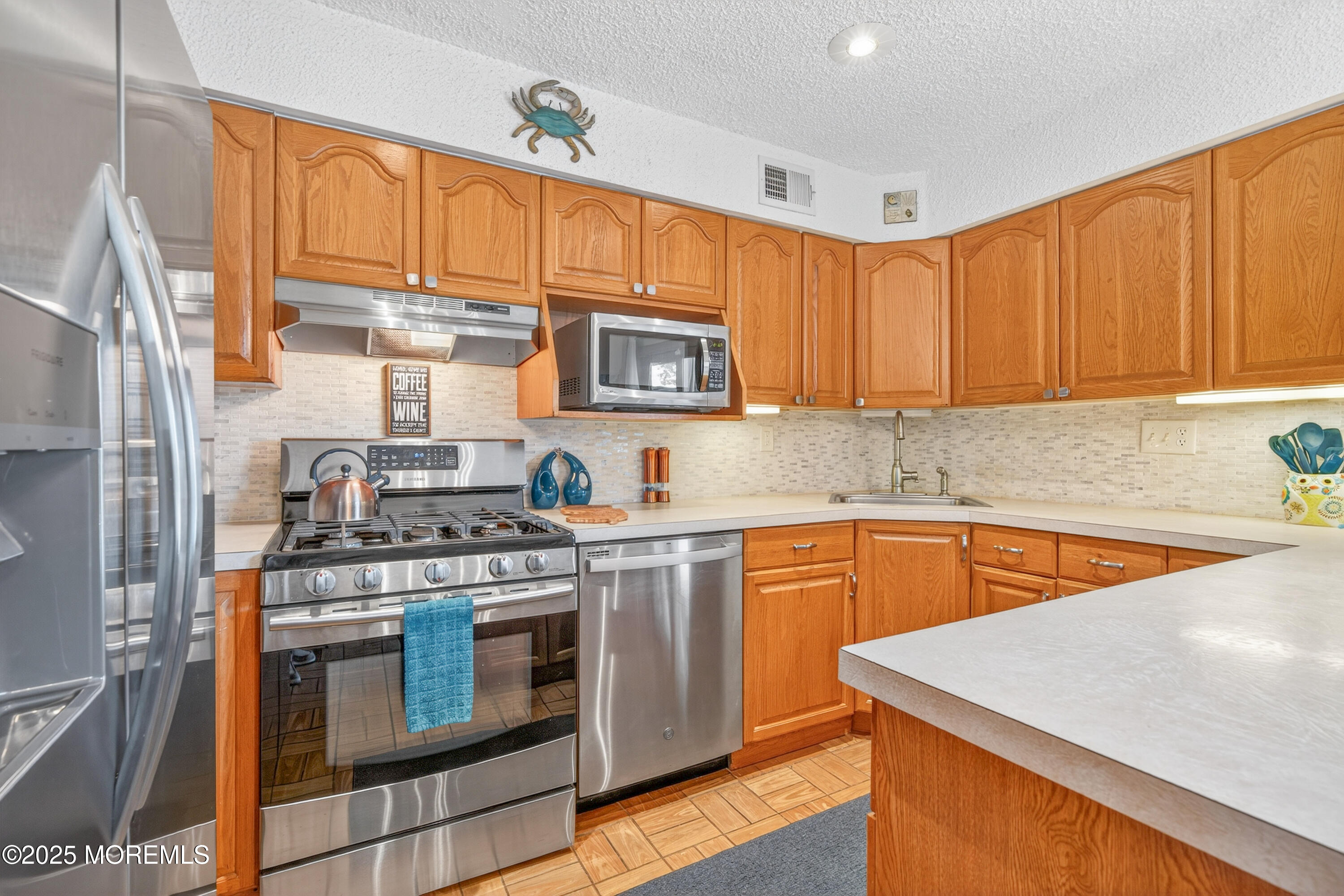 35 Heather Road Toms River, NJ 08753 - Photo 14 of 40 a kitchen with stainless steel appliances granite countertop a stove a sink dishwasher and a microwave oven with cabinets