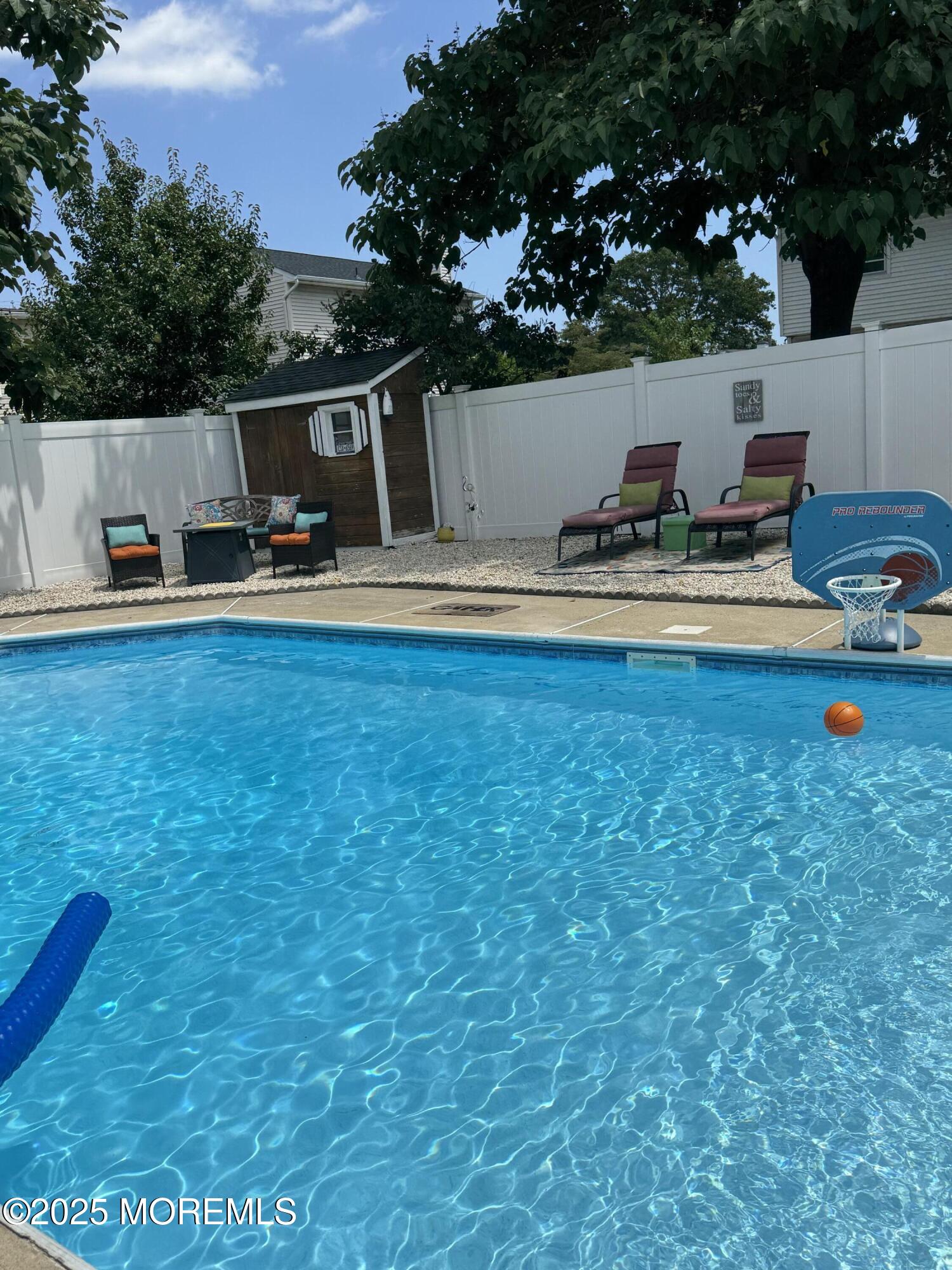 35 Heather Road Toms River, NJ 08753 - Photo 33 of 40 a view of a swimming pool with a patio and a yard