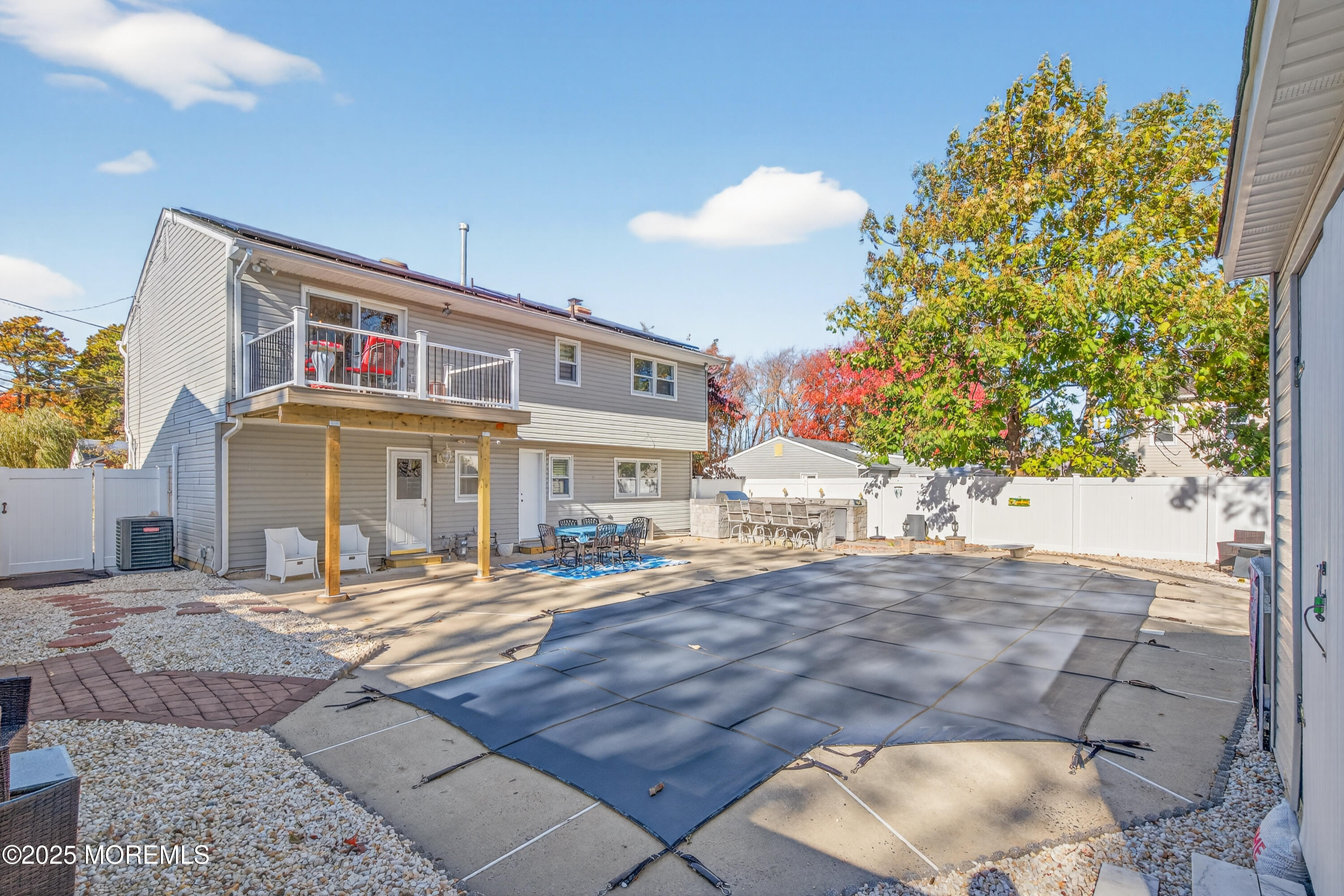 35 Heather Road Toms River, NJ 08753 - Photo 40 of 40 a patio with table and chairs and potted plants