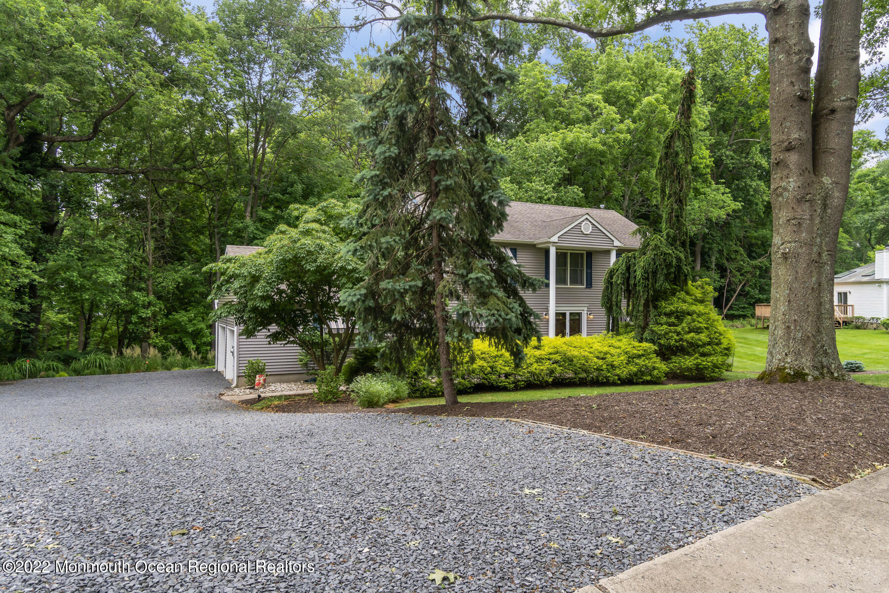 Front of house with oversize driveway
