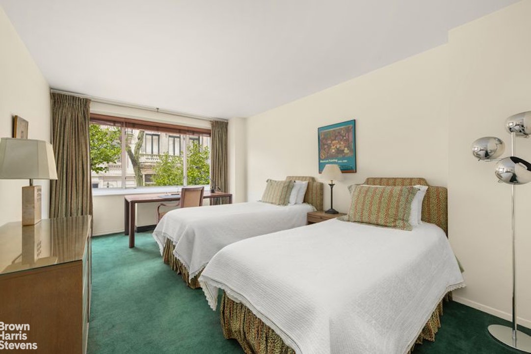 10 East 70th Street, Unit 2D Manhattan, NY 10021 - Photo 7 of 9 a bedroom with two beds and a large window